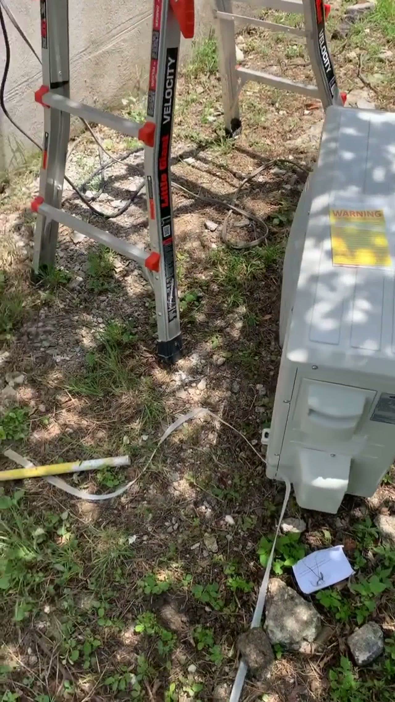 Technician on a ladder at a job site